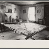 Elderly woman and girl with unfinished quilt in a suspended quilting frame. North Carolina?