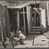 Negro backyard near Capitol, Washington, D.C. Negro children have just discovered the cameraman and are concerned at his presence.
