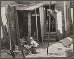 Negro backyard near Capitol, Washington, D.C. Negro children have just discovered the cameraman and are concerned at his presence.