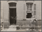 Front of Negro home near Capitol, Washington, D.C. Interiors of these homes vary little. A chair or two and a table, a bed and perhaps an extra mattress on the floor cares for six to ten people.