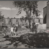 White girls playing in slum section near Capitol inhabited mostly by Negroes. Note Capitol dome in right background. Washington, D.C.