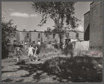 White girls playing in slum section near Capitol inhabited mostly by Negroes. Note Capitol dome in right background. Washington, D.C.
