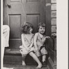 Small girls sitting in doorway of house in Georgetown, Washington, D.C.