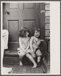 Small girls sitting in doorway of house in Georgetown, Washington, D.C.
