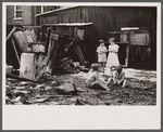 Slum children at play, Washington, D.C. Children in their backyard near the Capitol. This area inhabited by both black and white.