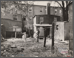 Children in slum area, Washington, D.C. Children in their backyard in a slum area near the Capitol. This area inhabited by both black and white.