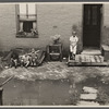 Front of old brick structure in section near Union Station, Washington, D.C. Land is low here and water collects in front and backyard after a rain and remains for many days. Entrances to privies are usually under water.