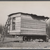 This one-room hut built of rough lumber over the chassis of an abandoned Ford truck was the housing provided by a landlord for an illiterate wood-cutter, with a wife and seven children.