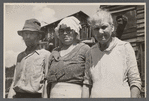 [Man and two women in front of shack. Alabama?]
