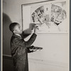 Photograph of teenager painting a mural design for the YMCA at a WPA art class