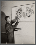 Photograph of teenager painting a mural design for the YMCA at a WPA art class