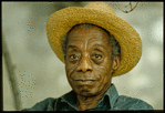 James Baldwin in straw hat