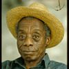 James Baldwin in straw hat