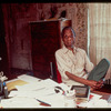 James Baldwin sitting at desk