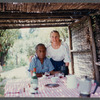 James Baldwin at bamboo-shaded table with guests at his home in France
