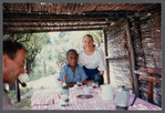 James Baldwin at bamboo-shaded table with guests at his home in France