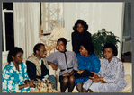 James Baldwin sitting with five women