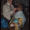 Adolf Senz applying makeup to trumpeter Abe Katz for L'elisir d'amore at the Metropolitan Opera