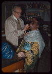 Adolf Senz applying makeup to trumpeter Abe Katz for L'elisir d'amore at the Metropolitan Opera