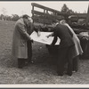 Officials examining plan of Greenbelt, Maryland.