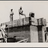 Rammed earth construction near Birmingham, Alabama. Three-inch layers are tamped in the forms until it is filled.