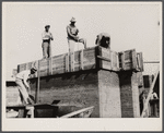 Rammed earth construction near Birmingham, Alabama. Three-inch layers are tamped in the forms until it is filled.