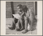Manpower, junior size. Two barefoot junior commandos in Roanoke, Virginia, wriggle their toes with delight as they study their instructions for collecting scrap for Uncle Sam's great army.