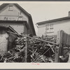 Close housing adjoining junk. Milwaukee, Wisconsin.