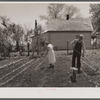 Off to a new start. Marion Hills and wife, rehabilitation clients, in garden of their farm. Center County, Iowa.