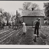 Off to a new start. Marion Hills and wife, rehabilitation clients, in garden of their farm. Center County, Iowa.