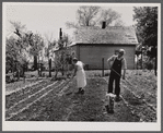 Off to a new start. Marion Hills and wife, rehabilitation clients, in garden of their farm. Center County, Iowa.