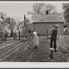 Off to a new start. Marion Hills and wife, rehabilitation clients, in garden of their farm. Center County, Iowa.