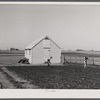 Granger homesteader working in garden. Iowa.