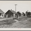 Street scene in the mining settlement of Zook Spur, Iowa, where part of the occupants of the Granger Homestead formerly lived. Each pump services four houses. Rent four dollars per month.