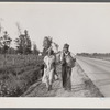 "Damned if we'll work for what they pay folks hereabouts." Crittenden County, Arkansas. Cotton workers on the road, carrying all they possess in the world.