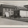 [Garage and house with farm equipment. Indiana?]