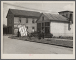 [Garage and house with farm equipment. Indiana?]