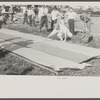 Firemen's muster. Boothbay center, Maine. Measuring the farthest drop of water on building paper which is unrolled fresh for each team. Distances were in the neighborhood of two hundred feet.