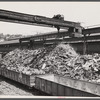 Steel manufacture. Back into production go these carloads of scrap metal. The melting of alloy steels for defense work requires that steel mill scrapyards such as this be constantly filled.
