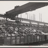 Steel manufacture, Allegheny-Ludlum. Back into production go these carloads of scrap metal. The melting of alloy steels for defense work requires that steel mill scrapyards such as this be constantly filled.