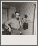 Earl Cazier, manager of St. Anthony stud service, receives call for bull. Fremont County, Idaho.