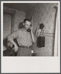 Earl Cazier, manager of St. Anthony stud service, receives call for bull. Fremont County, Idaho.