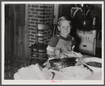 Child of former sharecropper eating at table. Southeast Missouri Farms.