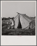 The Harry Stanfords, living in a makeshift tent in the same spot where their new trailer is parked now. Childersburg, Alabama.