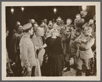 Publicity photograph of Rita Jolivet, L. Rogers Lytton, and unidentified others in the motion picture Lest We Forget
