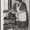 Older woman cooking meat for canning
