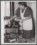 Older woman cooking meat for canning