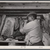 Butcher carving meat