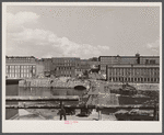 Amoskeag mills as seen from Bridge Street showing supports of Bridge Street from McGregor Street side, the upper structure of which was carried away in the March floods of the Merrimack River.
