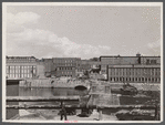 Amoskeag mills as seen from Bridge Street showing supports of Bridge Street from McGregor Street side, the upper structure of which was carried away in the March floods of the Merrimack River.